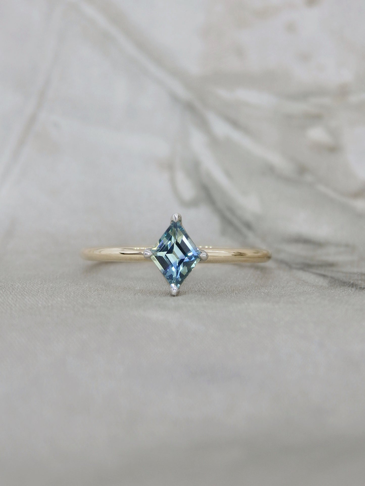 gold ring with blue parti sapphire