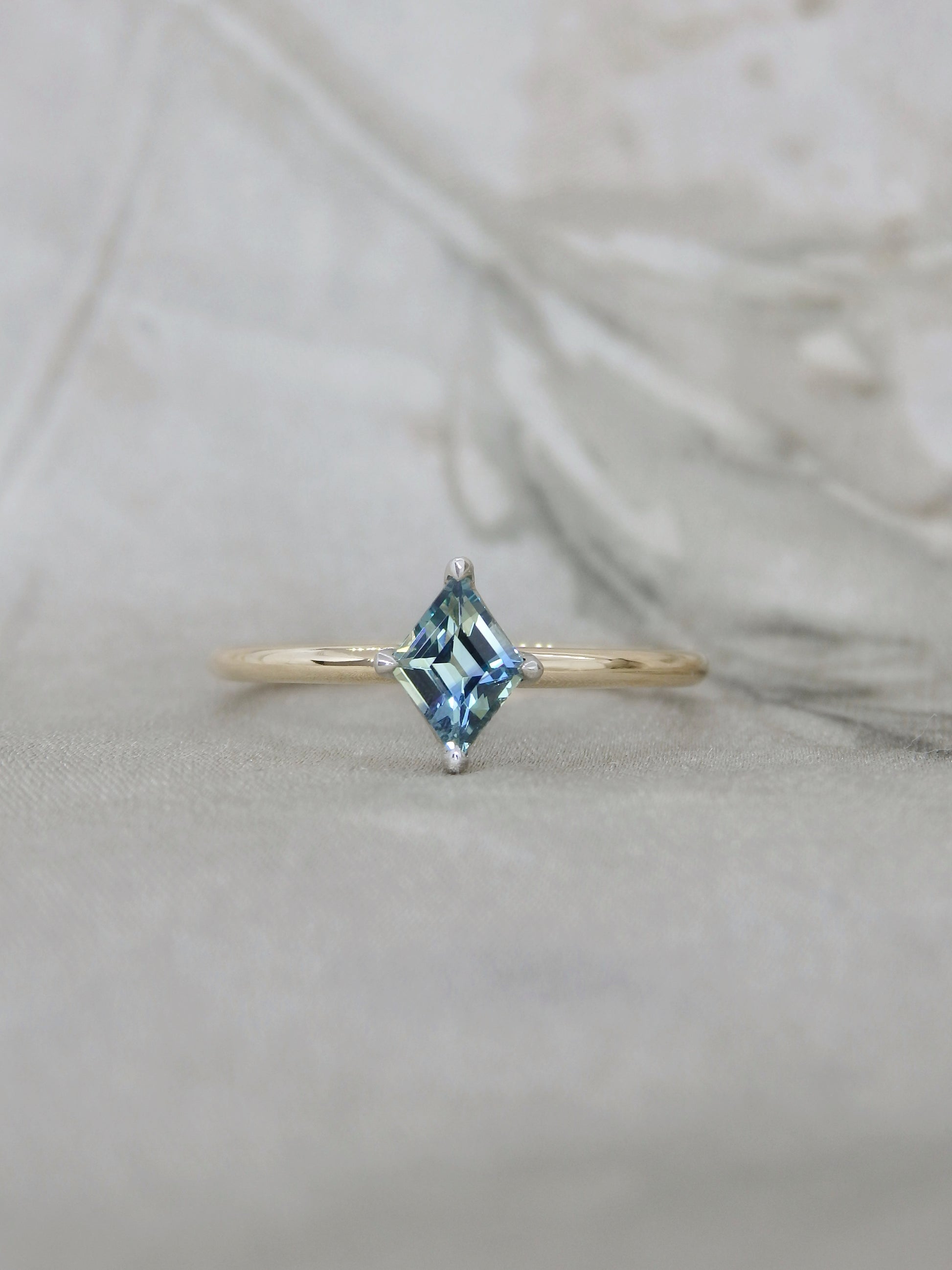 gold ring with blue parti sapphire