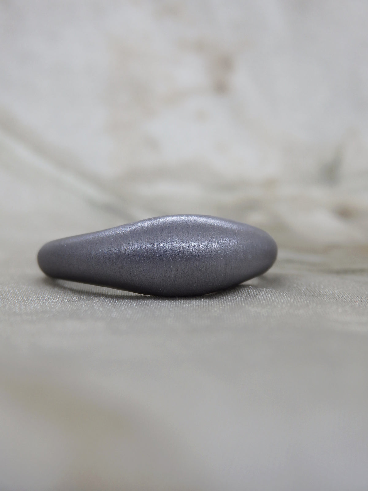 high domed signet-shaped tantalum ring with satin brushed finish before hand engraving and gemstones went in